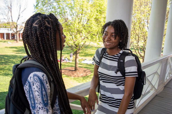 Two Black students talking