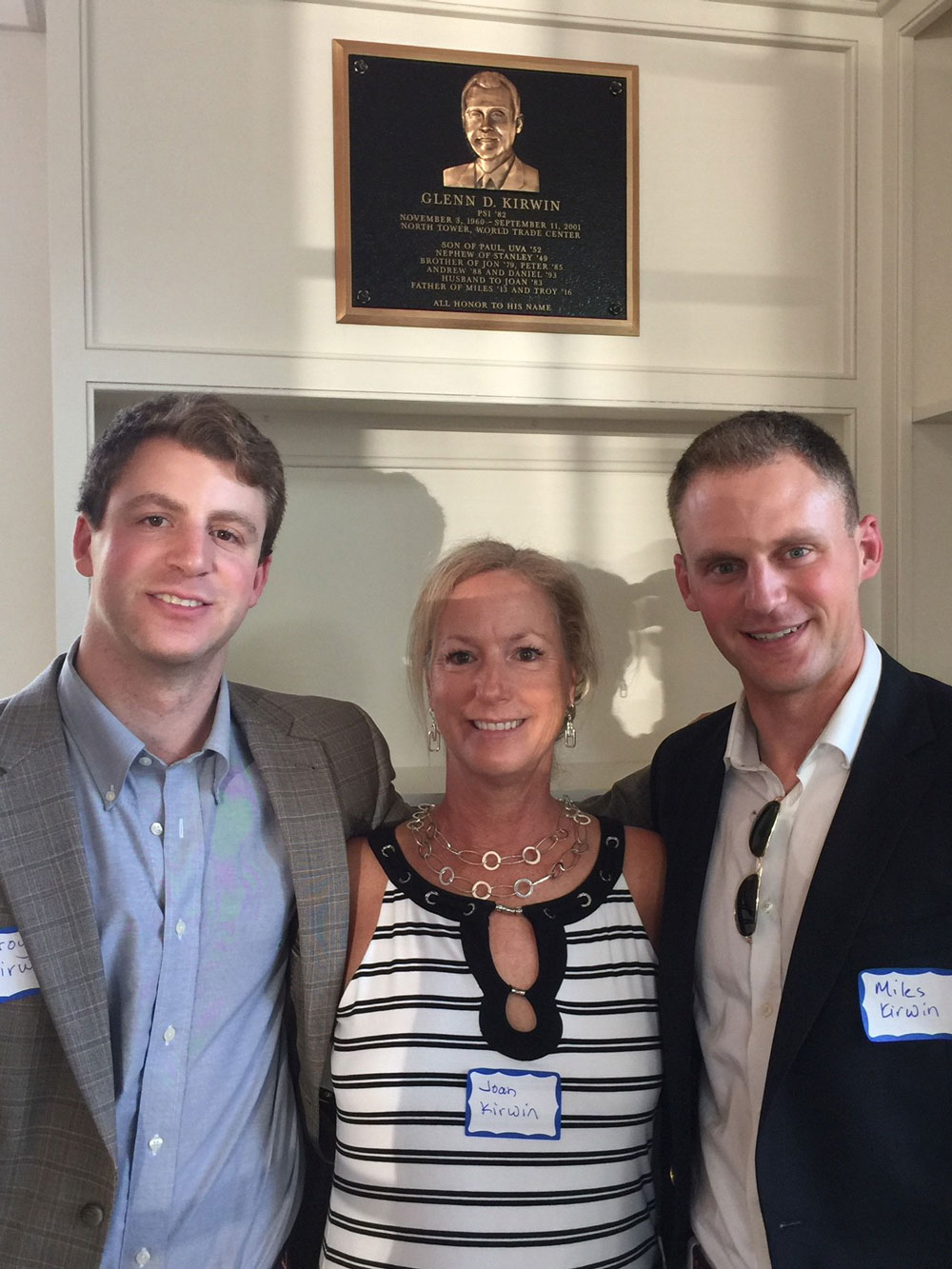 Troy, Joan, and Miles Kirwin in front of Glenn's plaque in Newcomb Hall